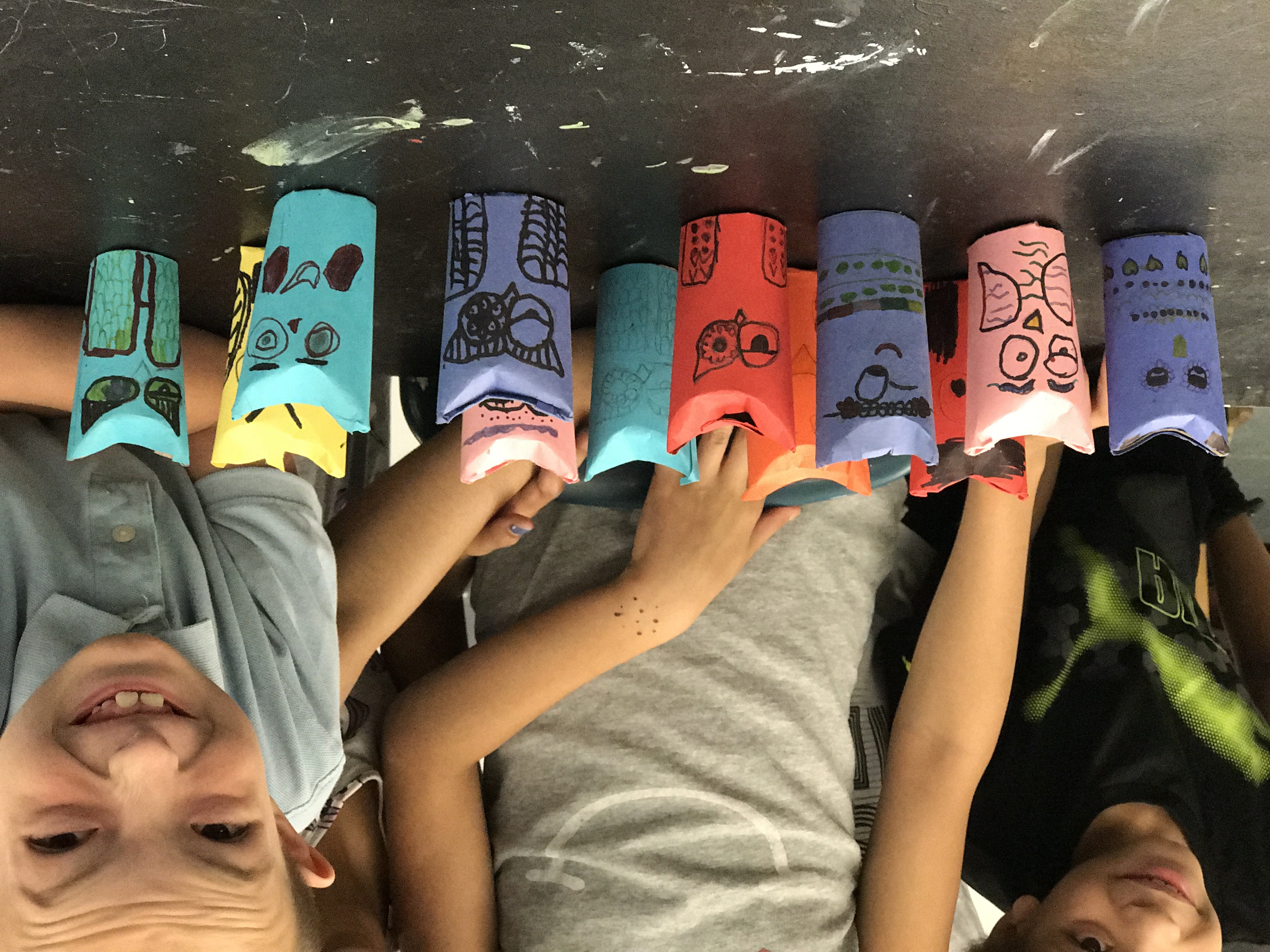 Students gathered behind their colorful handmade cardboard-tube characters